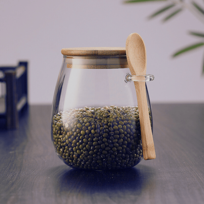 Pot hermétique en verre au design minimaliste avec couvercle en bambou pour une organisation élégante de la cuisine.